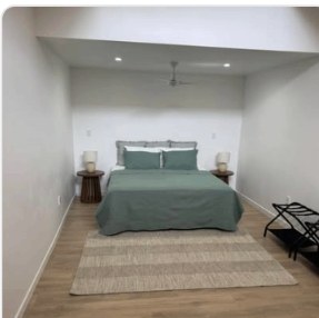Bedroom with dark timber flooring