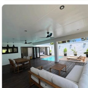 Open plan living opening onto pool deck