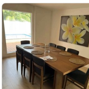 Timber dining table set with pool view